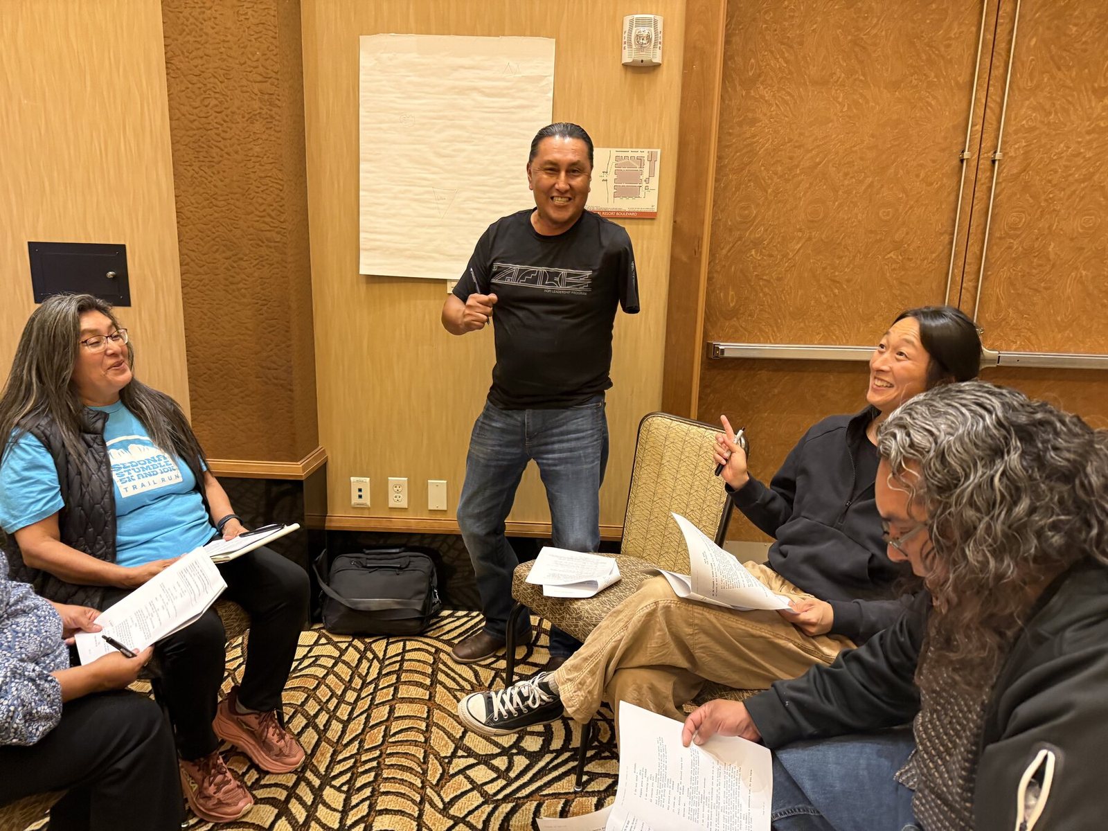 A table of participants reading the afternoon scripts together, laughing