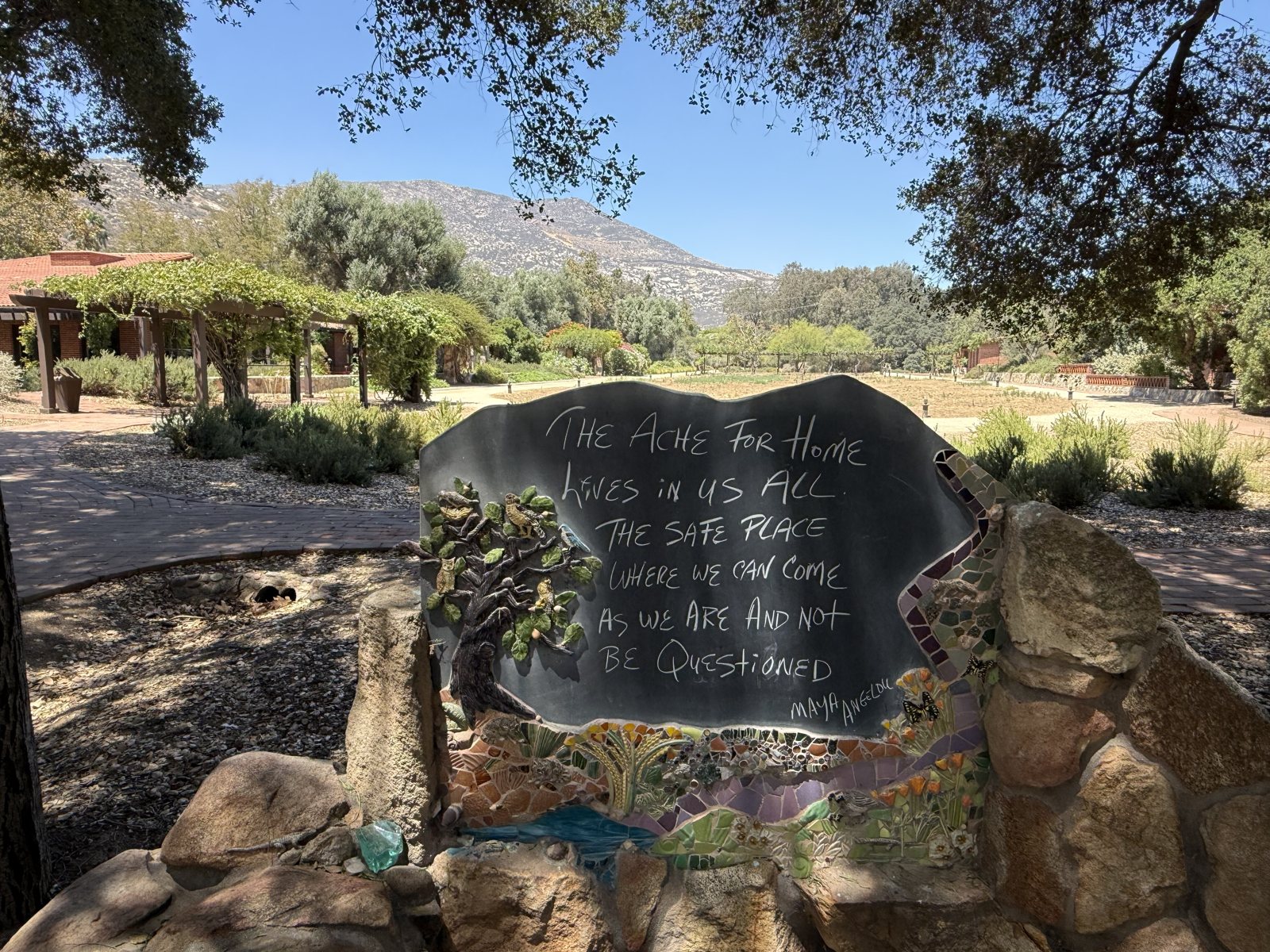 A painted stone on the path: The ache for home lives in us all, the safe place where we can go as we are and n